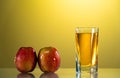 One glass of apple juice with red apples in the sunset background. Reflected surface. Summer day. Good mood. Royalty Free Stock Photo