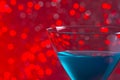 One glass blue cocktail on red background Royalty Free Stock Photo