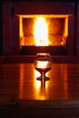 One glass of cognac on background of old brick fireplace Royalty Free Stock Photo