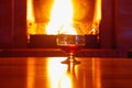 One glass of cognac on background of old brick fireplace Royalty Free Stock Photo