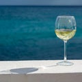 One glass of cold white wine served on outdoor terrace with sea Royalty Free Stock Photo