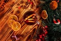 One glass cup of christmas mulled wine or gluhwein with spices and orange slices on rustic wooden table top view Royalty Free Stock Photo