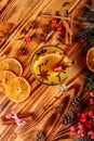 One glass cup of christmas mulled wine or gluhwein with spices and orange slices on rustic wooden table top view Royalty Free Stock Photo