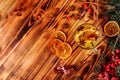 One glass cup of christmas mulled wine or gluhwein with spices and orange slices on rustic wooden table top view Royalty Free Stock Photo