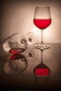 One glass half full the second lies, spilled wine, two red wine glasses on a white background Royalty Free Stock Photo