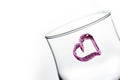 One glass with heart shape in purple color Royalty Free Stock Photo