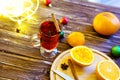 One glass mulled white wine on a rustic wooden table