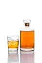 One glass of whiskey on the rocks, with a whiskey bottle in white background Royalty Free Stock Photo