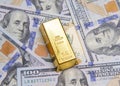 One gold bar with new american hundred dollar bills Royalty Free Stock Photo