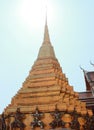 One of the golden chedi with the supporting giants around the base, , Wat Phra Kaew, Bangkok, Thailand