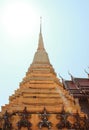 One of the golden chedi with the supporting giants around the base, , Wat Phra Kaew, Bangkok, Thailand