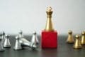 One golden king chess stand on red block and fallen silver king chess. Winner of business competition