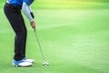 One golf player is putting a putter to the ball to hit the hole Royalty Free Stock Photo