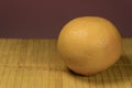 One grapefruit on a bamboo background Royalty Free Stock Photo