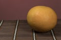 One grapefruit on a bamboo background Royalty Free Stock Photo