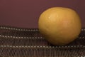 One grapefruit on a bamboo background Royalty Free Stock Photo