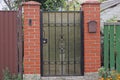 One gray closed metal door with a black wrought iron pattern Royalty Free Stock Photo