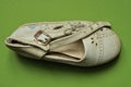 One gray dirty small summer leather sandal Royalty Free Stock Photo