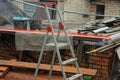 One gray folding aluminum ladder