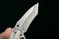 One gray folding knife in hand