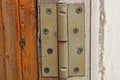 One gray iron door hinge on a brown white plank Royalty Free Stock Photo