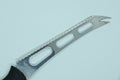 One gray metal cheese knife with a black plastic handle Royalty Free Stock Photo