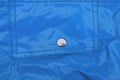 one gray metal rivet button on the blue leather pocket