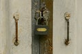 Gray padlock hangs on a closed iron door