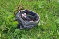 One gray plastic bicycle helmet lies in green grass Royalty Free Stock Photo