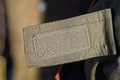 one gray plastic velcro on a green fabric harness Royalty Free Stock Photo