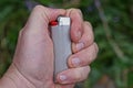 One gray red lighter in hand