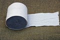 Gray toilet paper roll lies on a green cloth Royalty Free Stock Photo