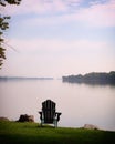 One green Adirondak chair along the river Royalty Free Stock Photo