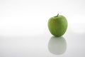 One green apples isolated on white background with reflex on glass