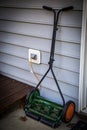 One green and black push mower