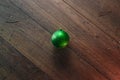 One green Christmas ball on a wooden background. Christmas and New Year. Copy space background. View from above Royalty Free Stock Photo