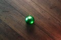One green Christmas ball on a wooden background. Christmas and New Year. Copy space background. View from above Royalty Free Stock Photo