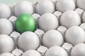 One green egg among many white eggs in the box, close-up. upstart and leader, symbol of individuality. concept for Royalty Free Stock Photo