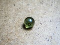 One green glass sphere on a wooden surface and caustic Royalty Free Stock Photo
