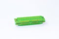 One green harmonica on a white background