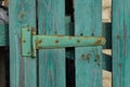 One green iron door hinge in rust on wooden boards Royalty Free Stock Photo