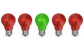 One green light bulb in row of red ones. Front view Royalty Free Stock Photo