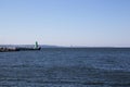 One green lighthouses at the entrance to the bay