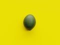 One green lime over a vibrant yellow background viewed from above Royalty Free Stock Photo