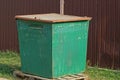 One green metalish trash can on the street Royalty Free Stock Photo