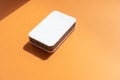 One grey kitchen sponges on the orange background Royalty Free Stock Photo