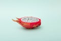 One half of dragon fruit or pitaya on green background Royalty Free Stock Photo