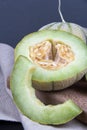 One and a half honeydew melon on a blou background. Royalty Free Stock Photo