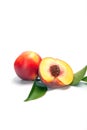 One and a half nectarine peaches on white background Royalty Free Stock Photo