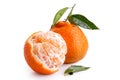 One half peeled and one whole mandarin with leaves isolated on w